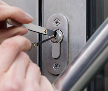 Locksmith unpicking a door lock due to resident been locked out of their home